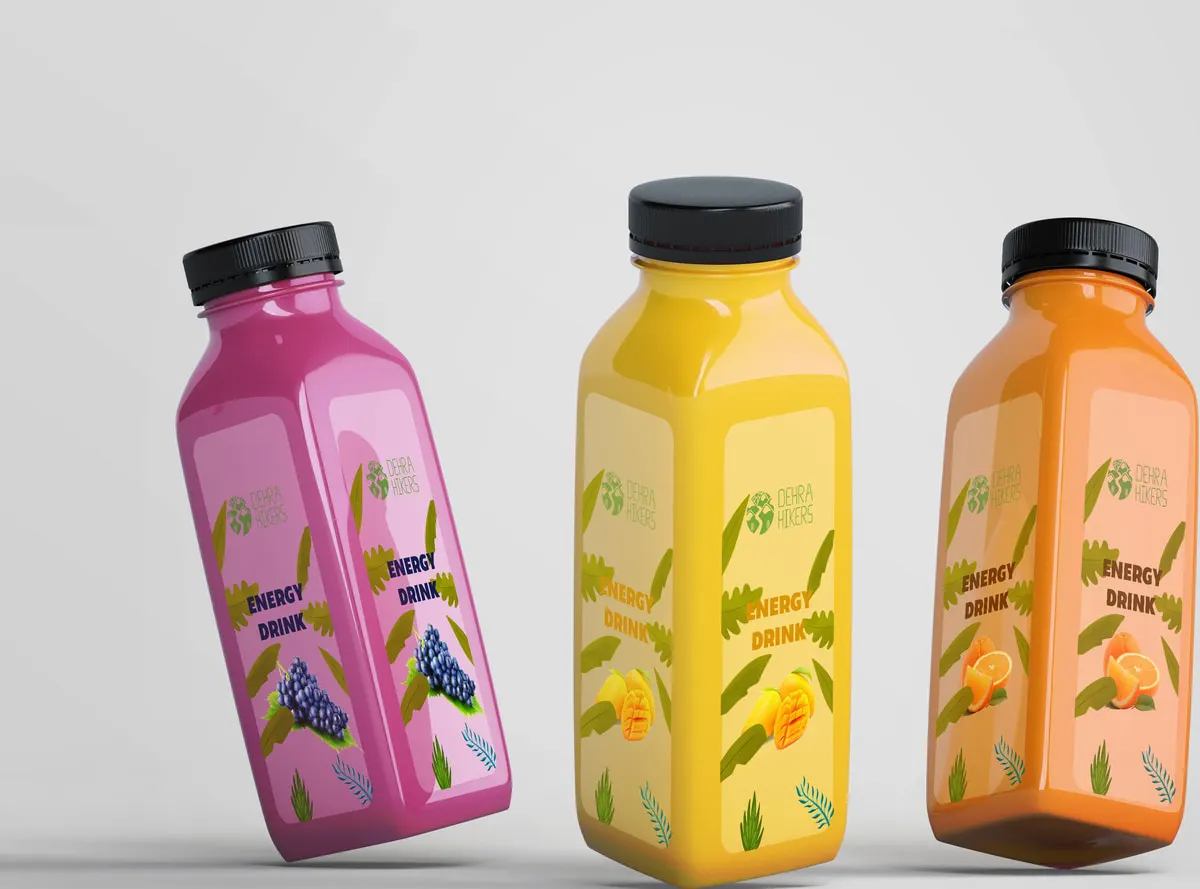 Three energy-drink bottles in magenta, yellow and orange, each printed with the Dehra Hikers mark and a pattern of the fruit it is made from.